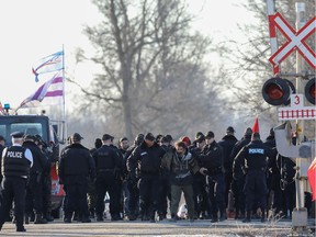 Police officers make an arrest during a raid on a Tyendinaga Mohawk Territory camp next to a railway crossing in Tyendinaga, Ontario, Canada February 24, 2020.   REUTERS/Chris Helgren