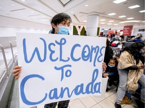 FILE PHOTO: Lyndon Gorospe waits for a family friend while wearing a mask at Pearson airport arrivals, shortly after Toronto Public Health received notification of Canada's first presumptive confirmed case of coronavirus, in Toronto, Ontario, Canada January 26, 2020. REUTERS/Carlos Osorio/File Photo