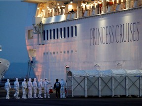 Officers in protective gear enter the cruise ship Diamond Princess to transfer a patient to the hospital after the ship arrived at Daikoku Pier Cruise Terminal in Yokohama, south of Tokyo, Japan February 7, 2020. REUTERS/Kim Kyung-Hoon/File Photo