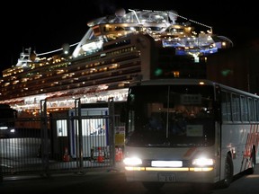 A bus transports British passengers after they left the coronavirus-hit cruise ship Diamond Princess at the Daikoku Pier Cruise Terminal in Yokohama, south of Tokyo, Japan, on Saturday, Feb. 22, 2020.