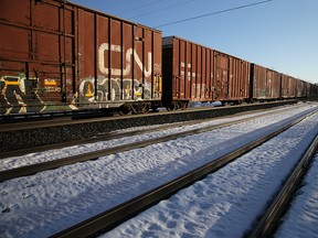 In this Feb. 21, 2020, file photo, A CN Rail freight train is halted while First Nations members of the Tyendinaga Mohawk Territory camp next to train tracks 2 km away as part of a solidarity protest with the Wet'suwet'en Nation against British Columbia's Coastal GasLink pipeline, in Tyendinaga, Ont.