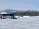 An STM bus does some drifting on the winter test track.
