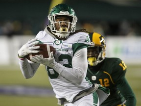 Saskatchewan Roughriders' Naaman Roosevelt makes the catch as Edmonton Eskimos' Forrest Hightower pursues in Edmonton on Oct. 26, 2019.