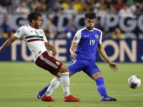 Haiti midfielder Steeven Saba, right, defends against Mexico midfielder Jonathan Dos Santos during the first half of a CONCACAF Gold Cup match on July 2, 2019, in Glendale, Ariz.