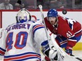 Canadiens forward Paul Byron tracks the puck near Rangers goalie Alexandar Georgiev during second-period action at the Bell Centre Thursday night.