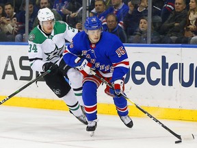 New York Rangers defenceman Ryan Lindgren plays the puck while being pursued by Dallas Stars right-wing Denis Gurianov during the first period at Madison Square Garden on Feb. 3, 2020, in New York.