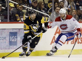 Dec 10, 2019; Pittsburgh, PA, USA;  Pittsburgh Penguins defenseman Kris Letang (58) moves the puck against Montreal Canadiens right wing Joel Armia (40) during the third period at PPG PAINTS Arena. The Canadiens won 4-1. Mandatory Credit: Charles LeClaire-USA TODAY Sports