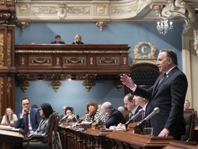Premier François Legault, right, responds to the opposition during question period Friday, February 7, 2020 at the legislature in Quebec City as Quebec Education Minister Jean-François Roberge, left, looks on. The government invoked closure to pass legislation on education reform.