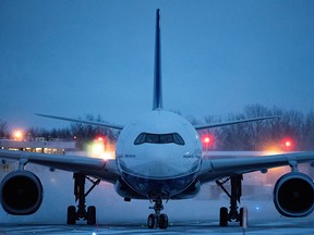 A plane carrying Canadian citizens from the centre of the global novel coronavirus outbreak in Wuhan, China, arrives at CFB Trenton on Feb. 7, 2020.