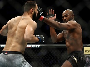 Dominick Reyes (left) takes a shot from Jon Jones in their UFC light heavyweight championship bout during UFC 247 at the Toyota Center on Saturday, Feb. 8, 2020, in Houston.