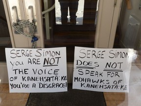 The doors of the Kanesatake Mohawk band council office are padlocked in Kanesatake, Que., on Wednesday, Feb. 19, 2020 as Kanesatake Mohawks protest after comments by their grand chief regarding rail blockades.