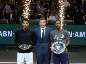 February 16, 2020,  France's Gael Monfils holds his plate as he celebrates winning the final, alongside Canada's Felix Auger-Aliassime who was runner up.