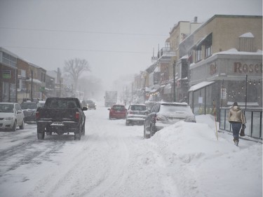 Vehicles were moving slowly, or socked in by snow plows, on snow-covered streets in Quebec City Friday, February 7, 2020.
