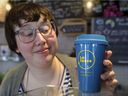 Émilie Lebel, owner of Café Perko, with a reusable consignment mug at her shop in Montreal's Villeray district Friday February 28, 2020. Lebel is president of an association of independent coffee shops and restaurants who are working together to reduce waste.