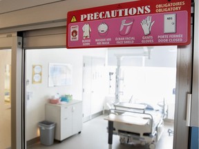 A sign clearly outlines the precautions before entering a room designated to treat potential COVID-19 patients at the Montreal Jewish Hospital in Montreal on Monday, March 2, 2020.