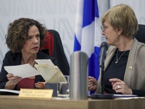 Côte-des-Neiges—Notre-Dame-de-Grâce borough mayor Sue Montgomery, left, speaks with Projet Montréal councillor Magda Popeanu during council meeting Wednesday night.