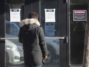 A man reads the closed signs on the Corona Theatre in Montreal, Quebec March 15, 2020.  (Christinne Muschi / MONTREAL GAZETTE)      ORG XMIT: 64102