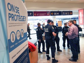 Montreal Police are briefed on their role aiding public health officials greeting travellers returning to Trudeau Airport in Montreal Monday March 16, 2020.
