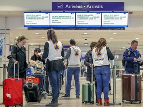 Travellers arriving at Trudeau airport in Montreal were met by officials from the Quebec public health department giving directives related to the coronavirus on Monday March 16, 2020.