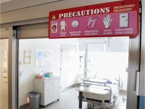 A sign outlines  precautions to be taken entering a room designated to treat potential COVID-19 patients at Montreal's Jewish General Hospital.