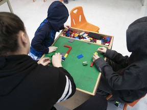 Kids and a daycare worker at a daycare that is part of the emergency response during the COVID-19 crisis.