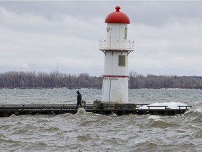 The water in Lac St-Louis comes close to cresting over the pier at 34th ave. in the Lachine borough of Montreal Tuesday March 17, 2020.