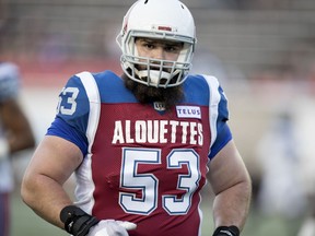 Montreal Alouettes' Philippe Gagnon  takes part in warmup before facing the Toronto Argonauts in Montreal on Aug. 24, 2018.