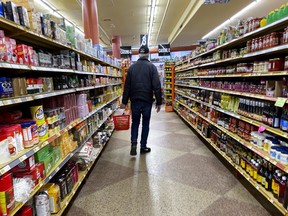 A shopper looks for groceries at Akhavan store as Montrealers deal with the coronavirus pandemic on March 26, 2020.