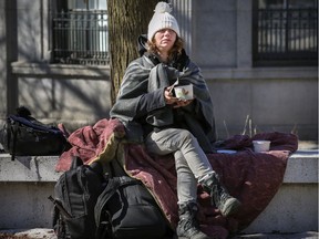 Victoria eats food provided by Resilience Montreal in Cabot Square in Montreal March 27, 2020.