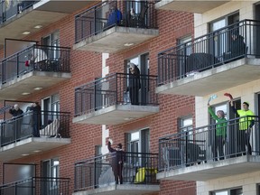 Seniors participate in an outdoor Zumba class from the balcony of a seniors' residence in Blainville on Friday March 27, 2020.