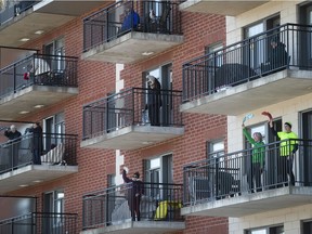 Seniors participate in an outdoor Zumba class from the balconies of a seniors' residence in Blainville on March 27, 2020.