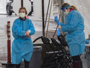 Nurses prepare to take the next nasal swab during a screening process at a COVID-19 drive through screening clinic in Côte-St-Luc on Sunday, March 29, 2020. The tests were by appointment only.