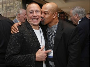 The good old days: Former Montreal boxing great Otis Grant plants a kiss on the cheek of former UFC champion Georges St-Pierre at the 15th Annual Sports Celebrity Breakfast Montreal Sunday, April 7, 2019 at the Cummings Jewish Centre.