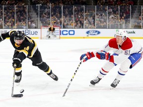 Canadiens defenceman Gustav Olofsson attempts to take puck away from Boston Bruins forward Chris Wagner during NHL game at TD Garden in Boston on Dec. 01, 2019.