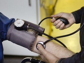 A physician takes a patient's blood pressure. "People are understandably concerned about COVID-19 and, unfortunately, in this climate of uncertainty, preliminary studies are often given much more credence than they deserve," Christopher Labos writes.