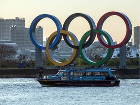 A man pulls up the anchor on a pleasure boat moored next to the Tokyo 2020 Olympic Rings on March 25, 2020 in Tokyo, Japan. Following yesterdays announcement that the Tokyo 2020 Olympics will be postponed to 2021 because of the ongoing Covid-19 coronavirus pandemic, IOC officials have said they hope to confirm a new Olympics date as soon as possible.