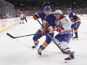 Canadiens' Brendan Gallagher and Islanders' Nick Leddy, left, battle for position during first period at the Barclays Center in Brooklyn on Tuesday night.