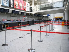GLASGOW,  - MARCH 18: A quiet Glasgow Airport with empty check in desks on March 18, 2020 in Glasgow, Scotland. People have been asked to work from home and socially distance themselves due to the coronavirus (COVID-19) pandemic.