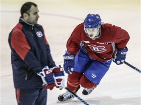 Winger Brendan Gallagher skates around Pierre Allard, director of sports science for the Canadiens, prior to a practice at the team's training facility in Brossard in 2015.  Gallagher was rehabbing a hand injury at the time.