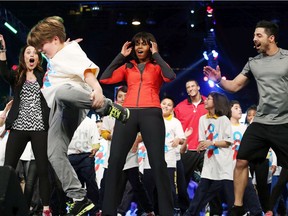 Former U.S. First Lady Michelle Obama dances with school children during a debut of a school exercise program Feb. 28, 2013 in Chicago.