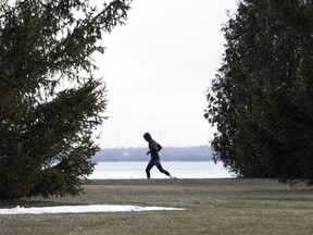 A runner enjoys the mild temperatures as he runs along the St. Lawrence River in 2019.