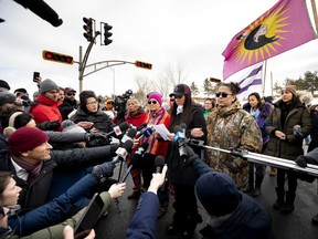 First Nations people from Kahnawake walk to highway 132 to announce they will move the blockade from the CP Rail tracks to a green space next to the Mercier Bridge in Montreal on Thursday, March 5, 2020.