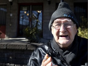 Jacques Lavigne, 78, sits outside his seniors' residence to enjoy some sun and have a smoke on Saturday. Quebec Premier François Legault has asked all citizens over 70 to stay home because of coronavirus concerns.