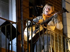 Martha Wainwright sings Leonard Cohen from the balcony of Pop Montreal during the coronavirus crisis in Montreal on Sunday, March 22, 2020.