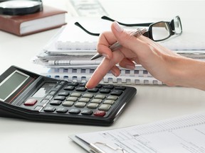 Close up of female accountant or banker making calculations.