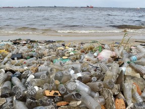 Plastic bottles and other waste lie on the sand after being washed ashore near the port of Abidjan on August 5, 2015. Images like these, among other factors, are making plastic into a pariah, Joe Schwarcz says.