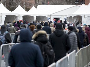 People line up for the screening process as the city begins mass testing for coronavirus in Montreal, on Monday, March 23, 2020. (Allen McInnis / MONTREAL GAZETTE)