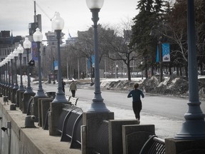 A jogger runs along the deserted path in the Old Port on Thursday March 19, 2020.