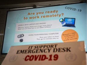A screen promoting remote working using a laptop or a mobile phone is displayed at the World Health Organization (WHO) headquarters in Geneva to promote the fight against COVID-19, the disease caused by the novel coronavirus, on March 11, 2020 in Geneva.