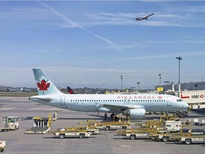 In this file an Air Canada plane sits on the tarmac at Montreal's Trudeau airport. (Photo by Daniel SLIM / AFP)
